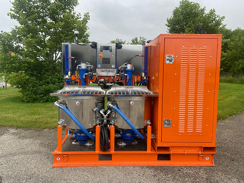 A large orange machine with two tanks on it.