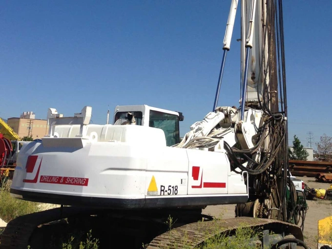 white backhoe with crane