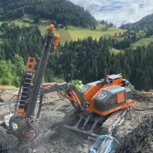 A machine working on an orange hillside.