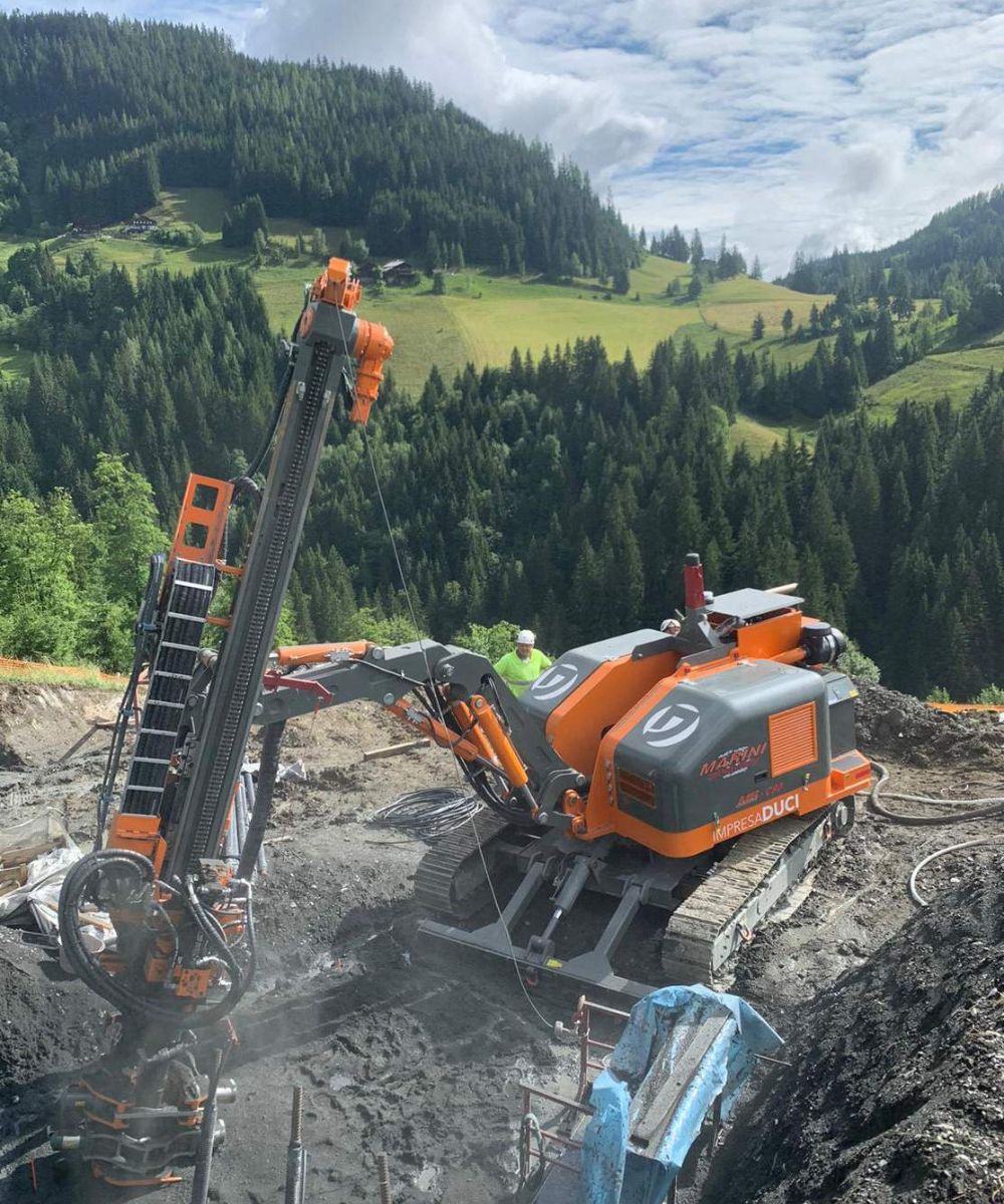 A machine working on an orange hillside.