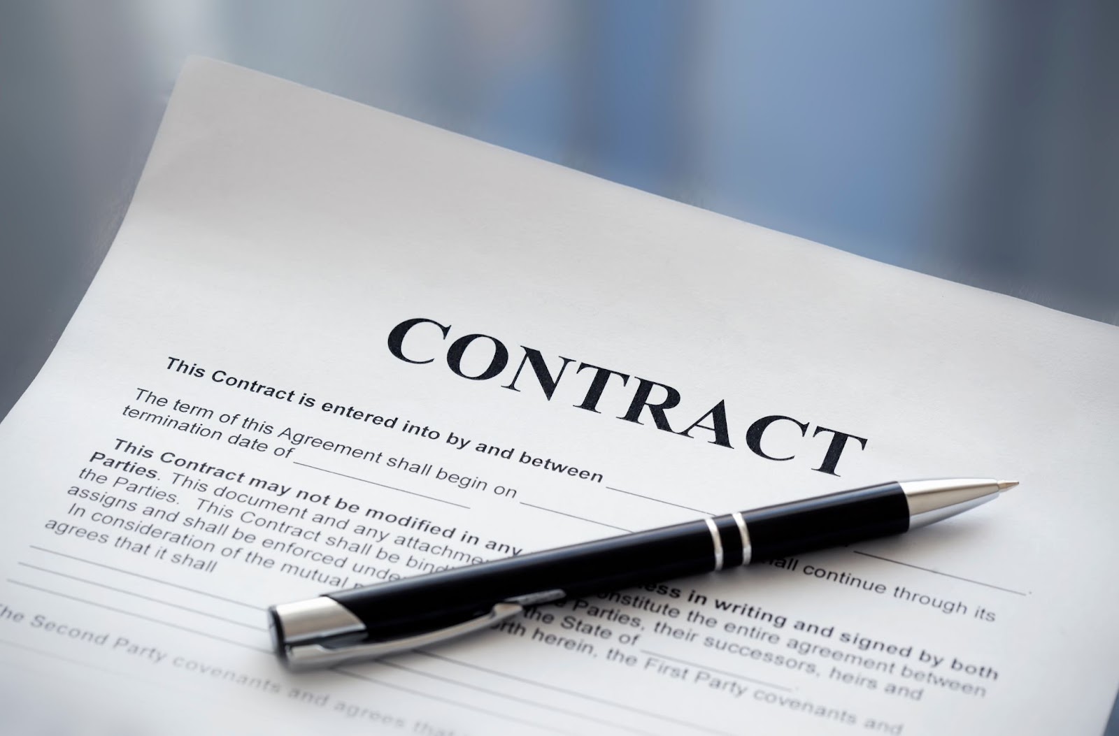 A contract document with a pen resting on it.