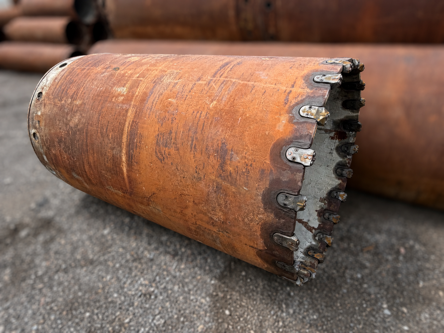 Rusty Industrial Boring Sleeve on Gravel