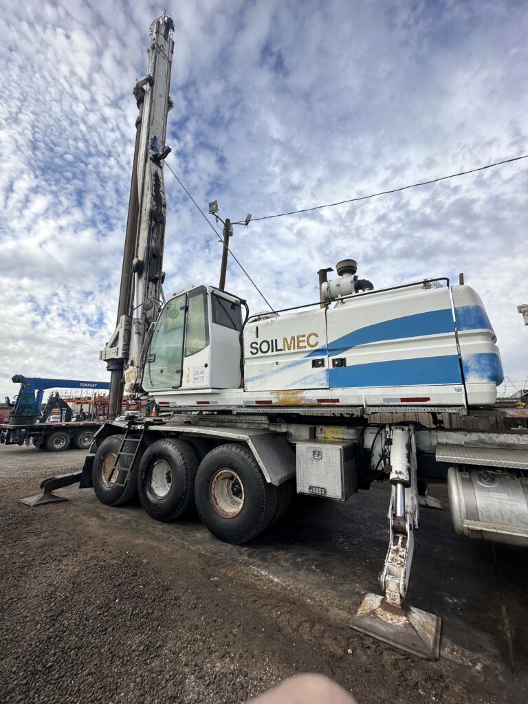 A large crane perched on a truck, featuring Soilmec A312 sn2063 Truck Mounted Drill Riglling Rigs USA Logo
