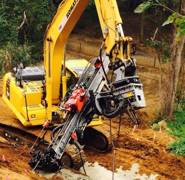 A construction machine excavates a large hole for building