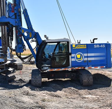 soilmec sr-45 tracked drilling rig with extended mast on dirt construction site